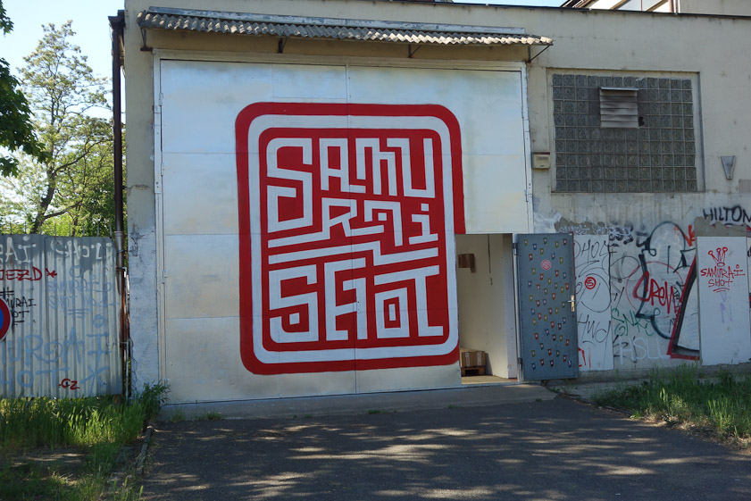 We saw this as we walked north from the Trade Fair Palace to see a new bridge. Handsome sign or precise graffito?