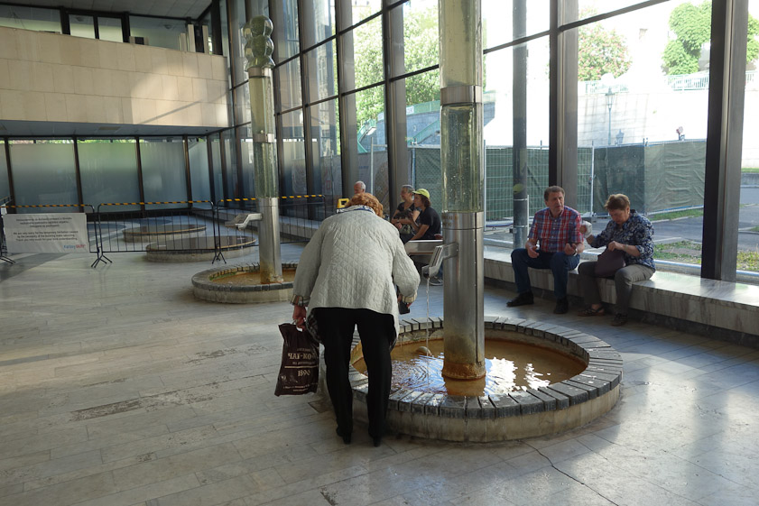 A customer filling her cup at the municipal Hot Spring Colonnade
(Vřídelní kolonáda)