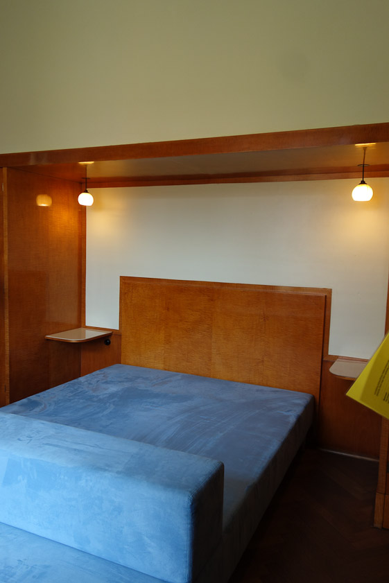 The bedroom has built-in tables, cupboards, drawers, closets, and even a safe.