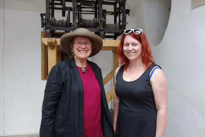 Our tour guide and Mariana in front of a clock mechanism.