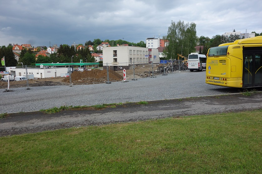 The white building is the bus station. Its only useful function was the toilets. It had no information displays: no schedules, no map of stops, no information about Cesky Krumlov, no directions for waling into town. It was being renovated.