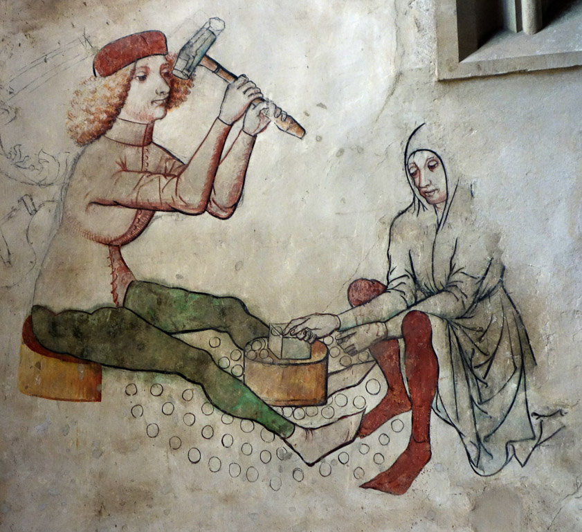 Our guide book says this pair of minters are flattening blank discs to later be impressed with a design.