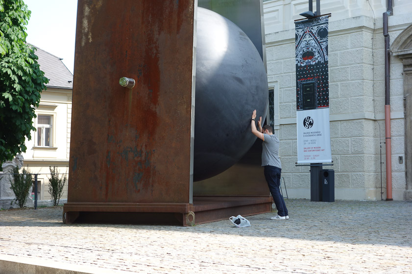 He's making the ball roll, like Sisyphus .