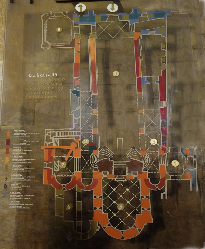 The oldest parts of the structure (10c) are orange: the crypt (5). Dark red marks work of the 11c. Blue work is late 17c and green is early 13c (6, the Chapel of St. Ludmila(). There are towers over 4 and 7,
