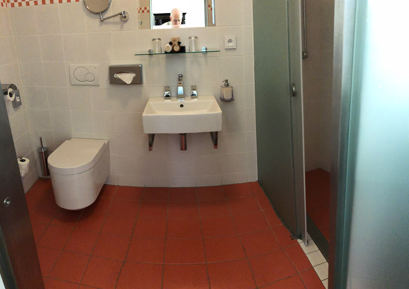 A modern toilet and shower.