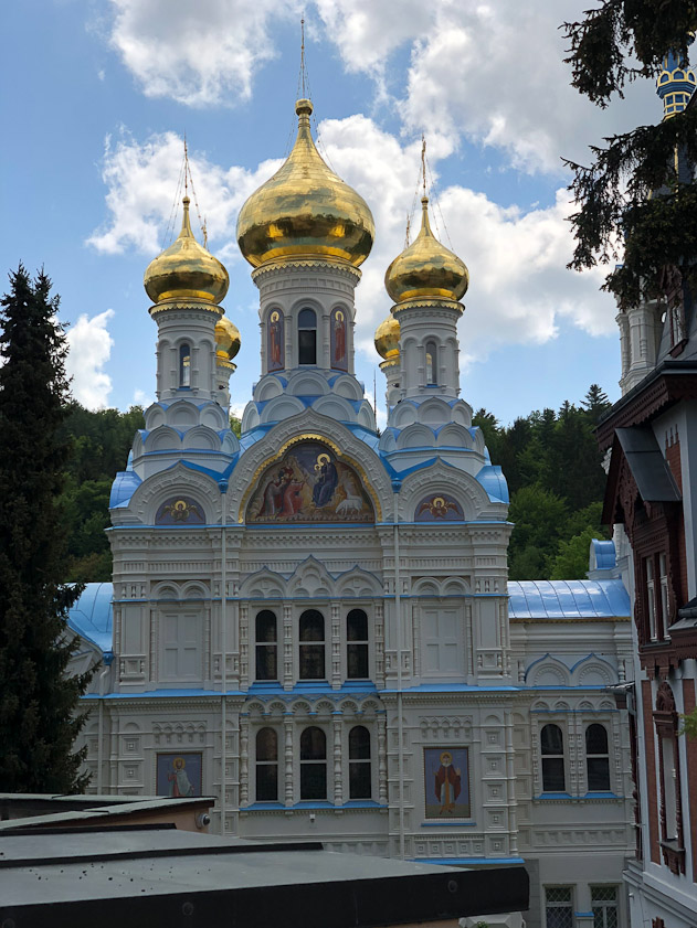 A view from the north. The church consists of an entrance hall on the west (to the right) and a square room at the east under gold domes.