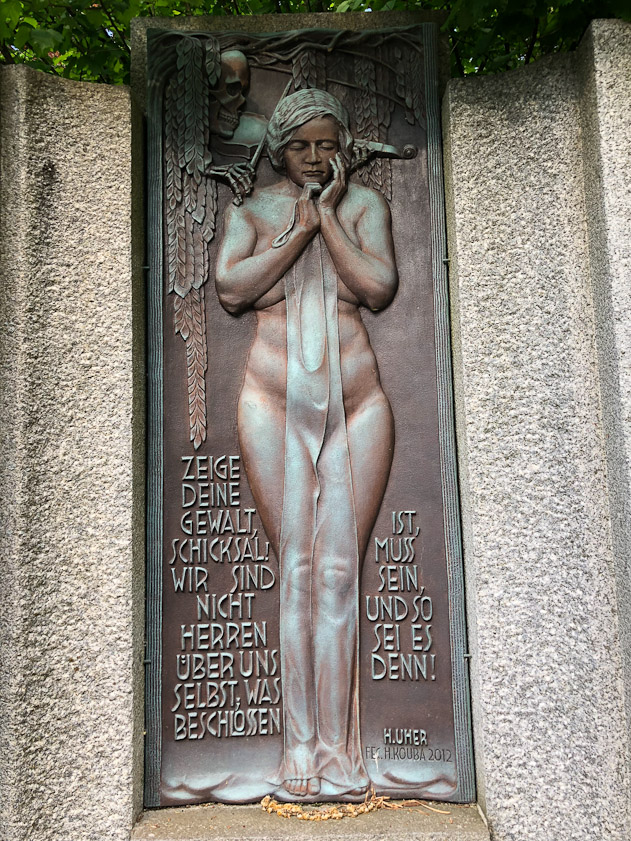 This relief is a copy, one of a pair installed in 2012. The orginals were removed in1946 because of the German text. The original sculptor, a German, died in prison in Prague in December 1945.