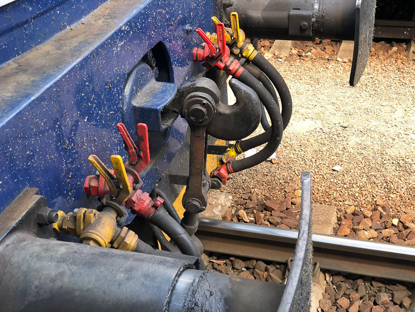 The buffers (at top and bottom) hold Czech railroad cars apart, and the chain (the hook in the middle between the hoses) helds them together.