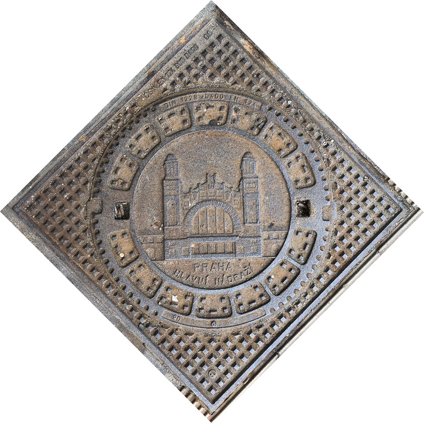 Manhole cover in Prague, showing the main train station.