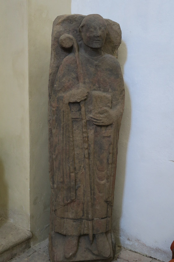 Various old gravestones are stored inside.