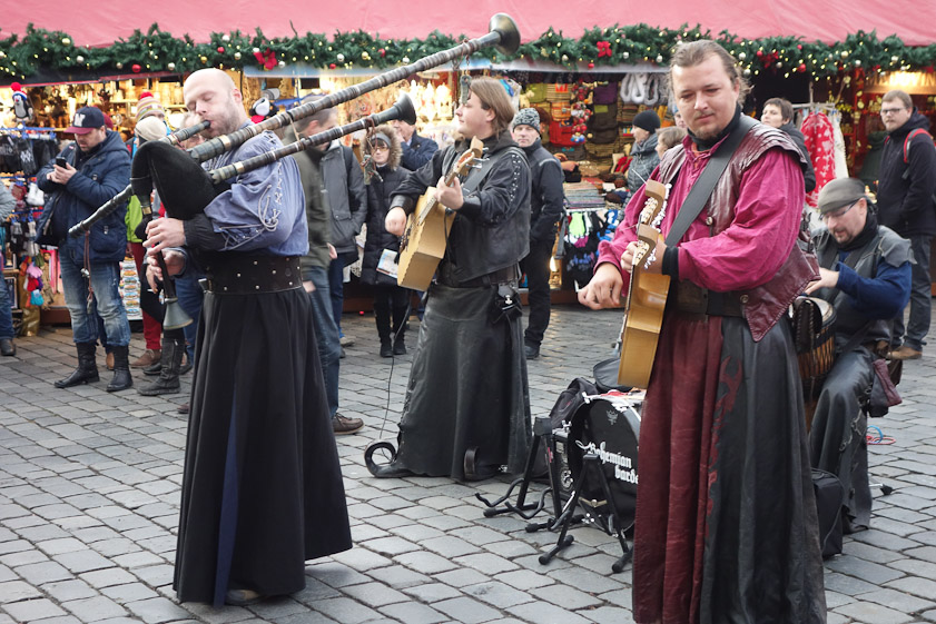 Musicians at Christmas market. Note the two necks on the instrument at the right.
