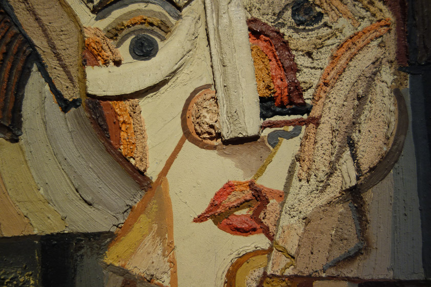 A closeup shows the varied texture of the painting.