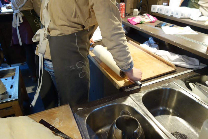 The spiral of dough is rolled to make a cylinder.