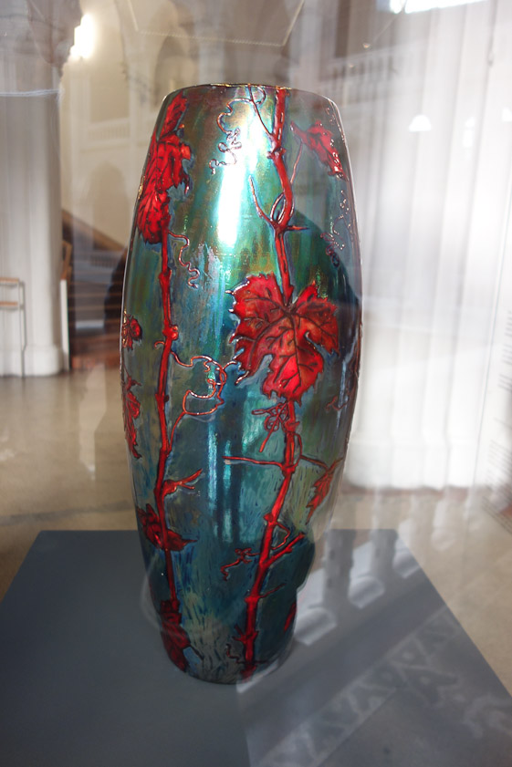 Vase with vine shoots, Zsolnay,1899. Fine white earthenware with slip underglaze painting and eosin glazes. This vase was made for the 1900 Paris World's Fair using a reduction-fired metal lustre glaze called 