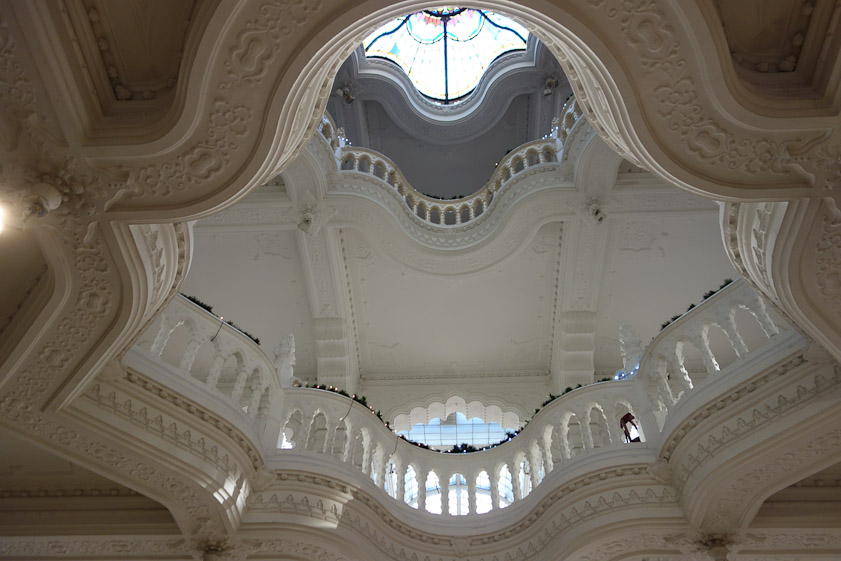 The second  and third floors are visible through a multi-lobed opening in the ceiling.