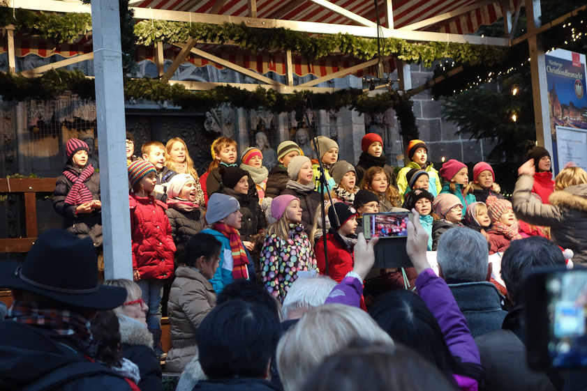 Children's chorus singing at Frauenkirche market.