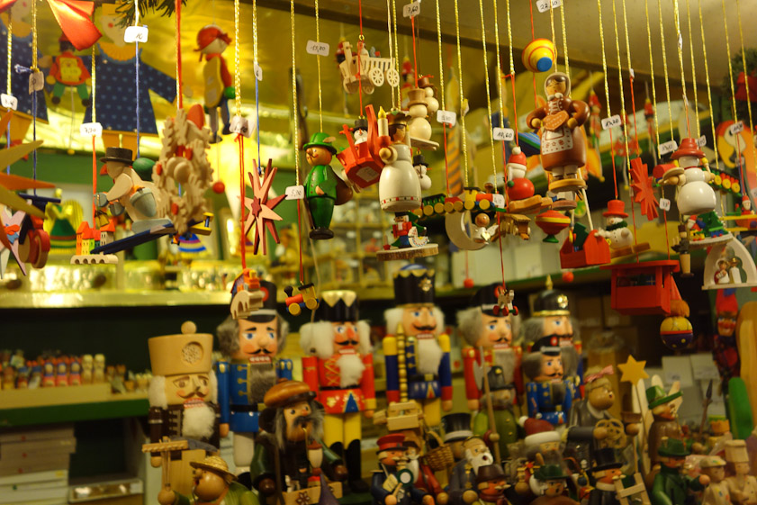 Painted wooden figures in a Christmas market stall.