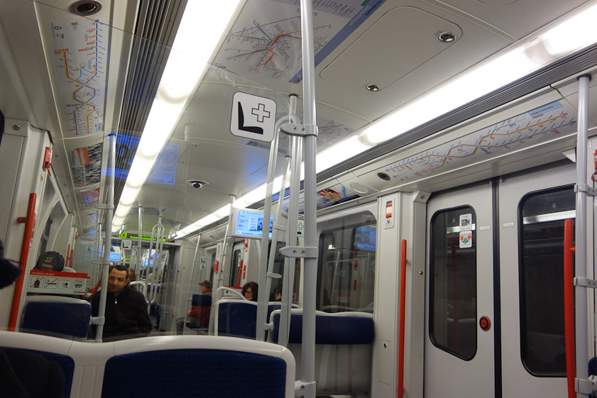 Interior of a Nuremberg U-Bahn car. Possible video surveillance camera in the ceiling. Computer display to the right of it giving route information.