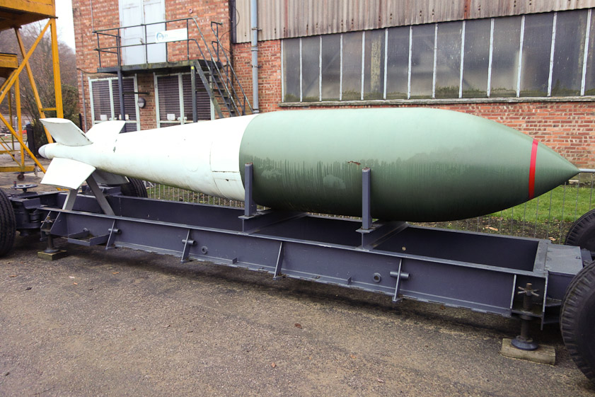 This is a Tallboy bomb, 12,000 lbs, designed by Barnes Wallace with numerous unusual features to allow it to penetrate deep into the groud (or water) around the target before exploding. Its streamlined, elongated shape allowed it to achieve high terminal velocity. Slightly canted tail fins imparted spin that stabiized its attitude. The nose was hardend steel and the casing was another special steel to keep the bomb intact on impact. Three detonators and a timer in the tail made misfires unlikely. It was usually dropped by a Lancaster from 18,000 feet. About 854 were hand-built, so expensive that they were not jettisoned if not used but brought back and landed.