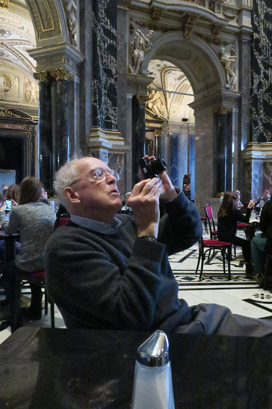Tourist lining up a photo while waiting for lunch to arrive in the KHM.