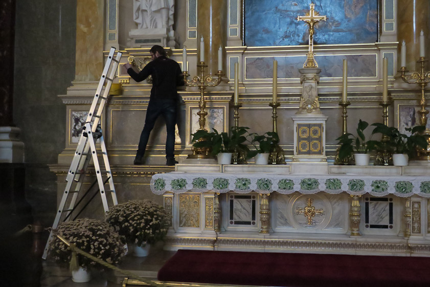 Custodian cleaning inside St. Stephen's