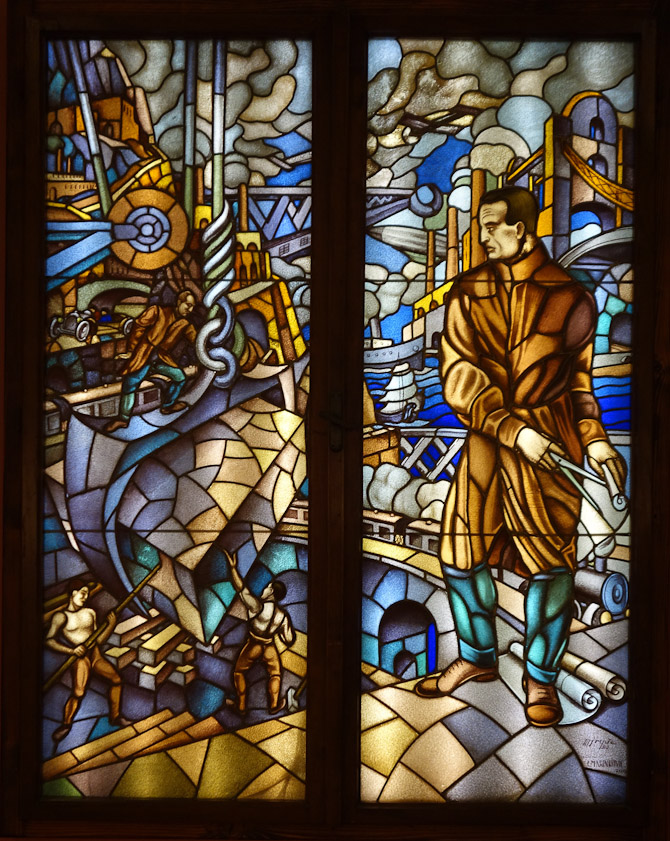 In contrast to the bucolic, this stained glass has a modern, mechanical theme