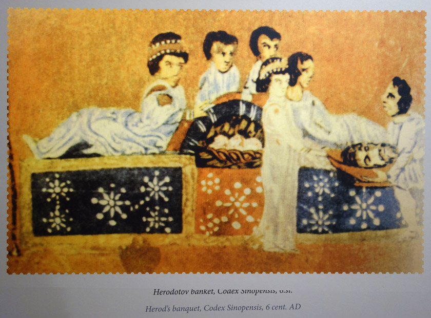 This scene from a 6c codex shows how diners reclined in a semicircle around a shared mensa. The platform that supports the diners and mensa is the triclinium. The scene depicted here is display of the head of John the Baptist to Salome.