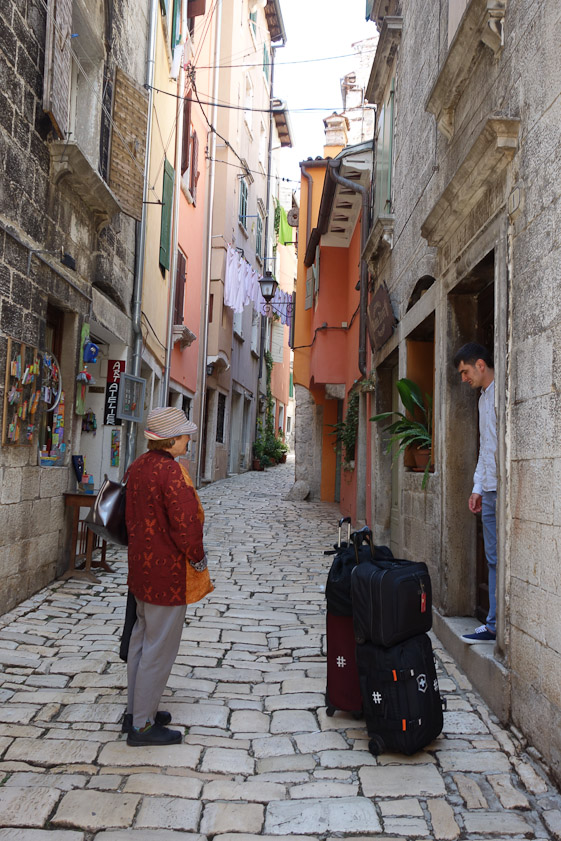 The host standing in the doorway of the house where we had reserved a room. He was about to show us the way to our room.