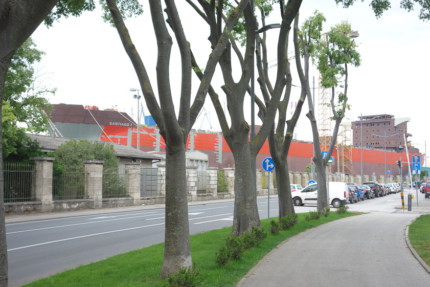 A gigantic ship being assembled by Uljanik moored to the shore. The two halves were built on the island, then towed here to be joined.