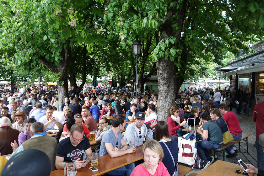 Seating is tight in the beer garden. The man in the Hard Rock T shirt is close to touching the man behind him.