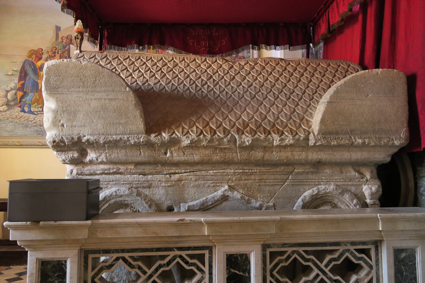 The 6c Roman sarcophagus behind the main altar.