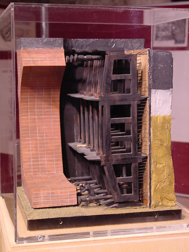 This model of the tunnel shield shows screw jacks used to push the shielf forward after the 36 miners had excavated a few inches from the face.