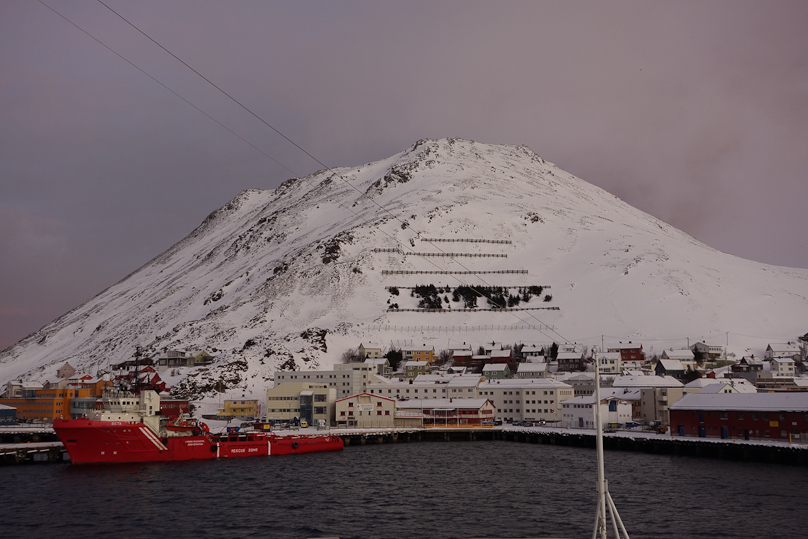 Honningsvåg is protected from avalanches by snow fences on the steep mountainside behind it.