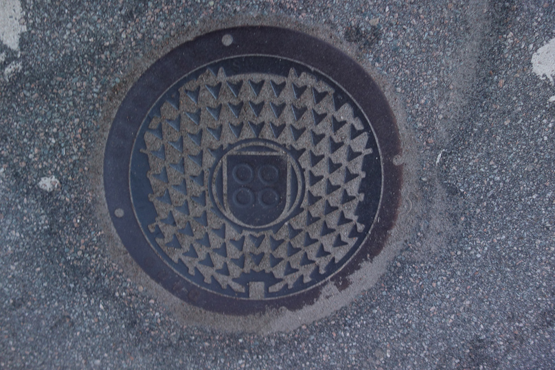 Manhole cover in Stokmarknes. The four rings are symbols of the four islands on which the town is located.