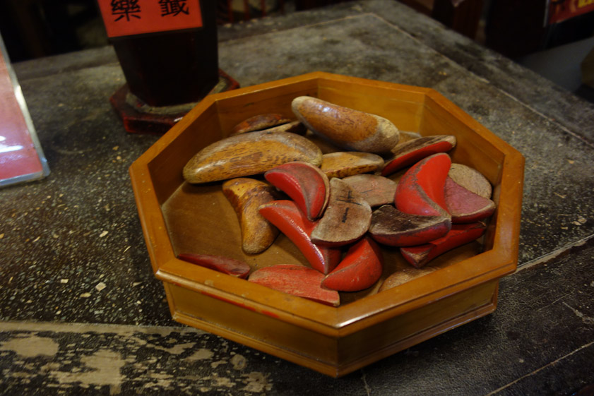 Two divining blocks are thrown to get the god's answer to a person's yes/no question. Two curved sides landing up means the answer is 