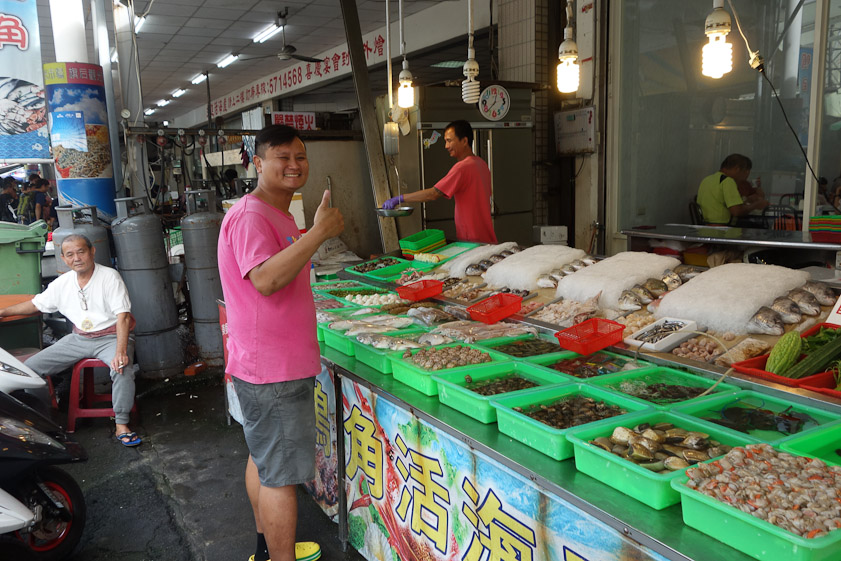A customer endorsing our lunch restaurant. There is no menu, just an array of fresh fish to choose from. You choose the fish, and it is put in a bsket with a slip of paper specifying how it is to be cooked. You go inside, get a table, and wait for your order.