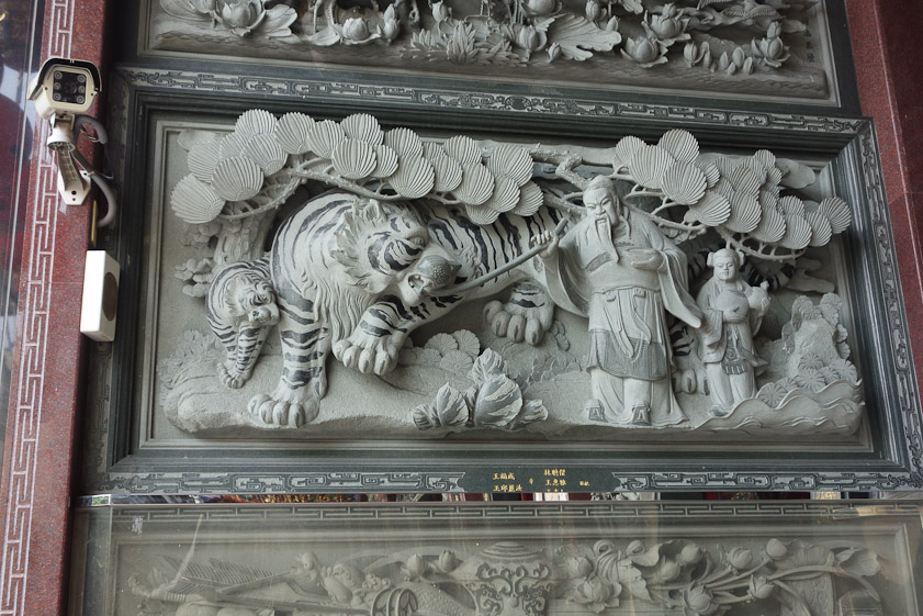 This panel in a doorway tells the story of a sage who removed a painful object from a tiger's mouth.