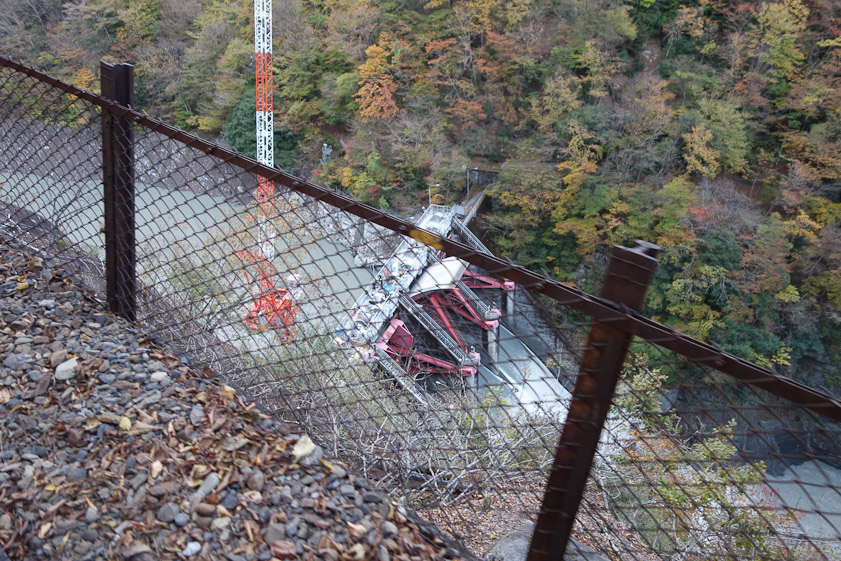 A dam below us with gates that can adjust the water flow and height of the lake upstream.