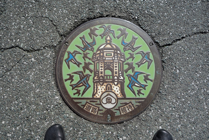 Manhole cover at the foot of the 1,129 steps in Negoya, Shizuoka, Japan.