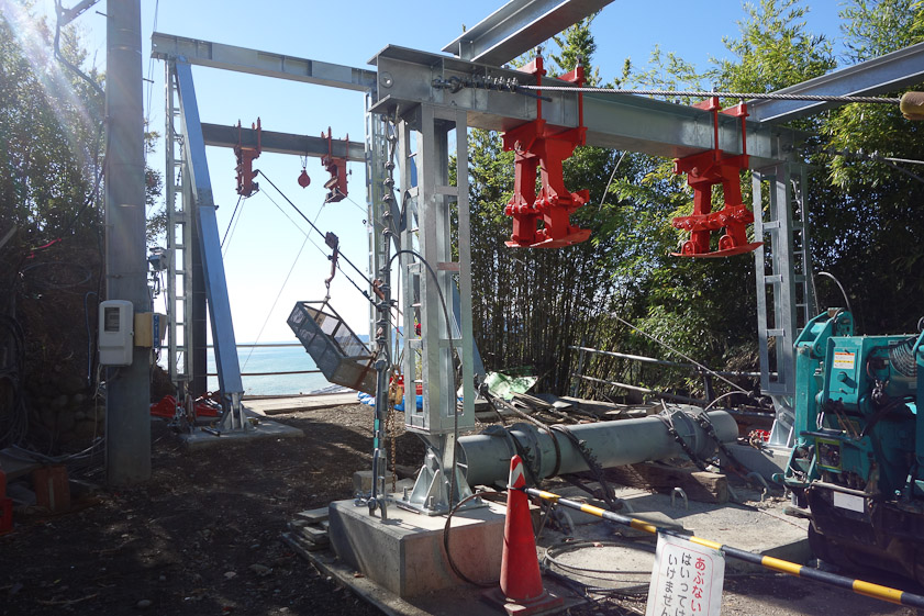 This is a temporary ropeway to bring construction material up to the shrine. It is at level 1 near the toilets.