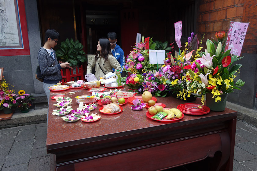 Food and flower offerings in the back court.
