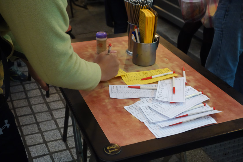 We filled out our order at one of the food stands with help from another customer.