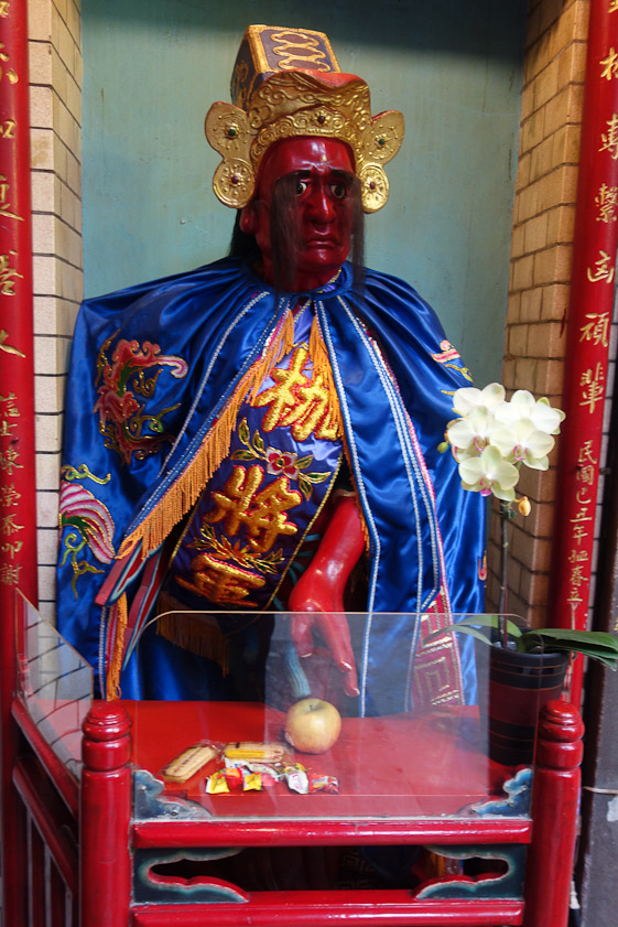 An effigy with some food offerings in front of him.