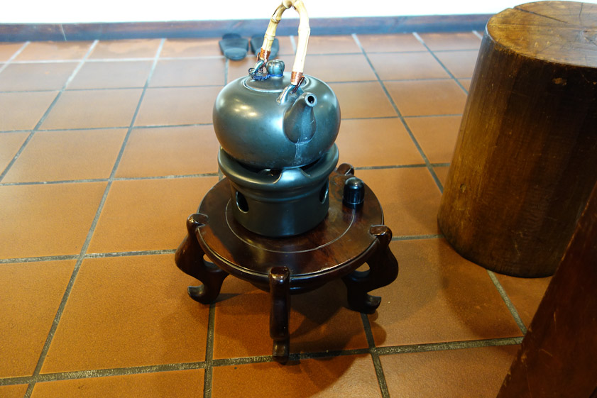 Water was kept hot in this kettle with a candle under it. We saw on logs.