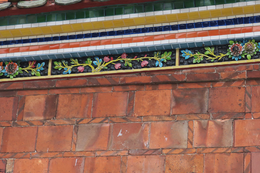 The wall is faced with baked tiles.