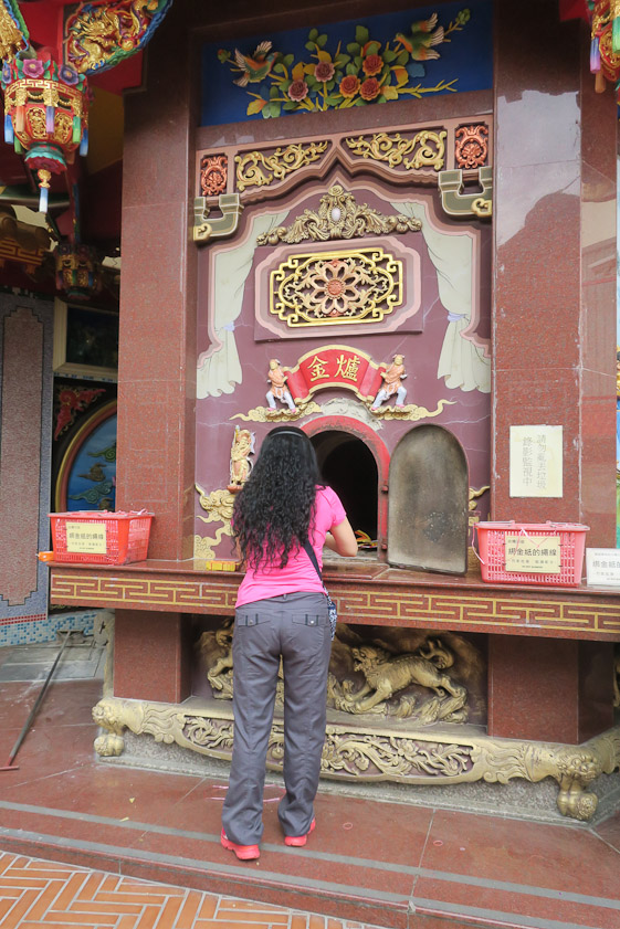 She was pushing stacks of joss money into the flames.