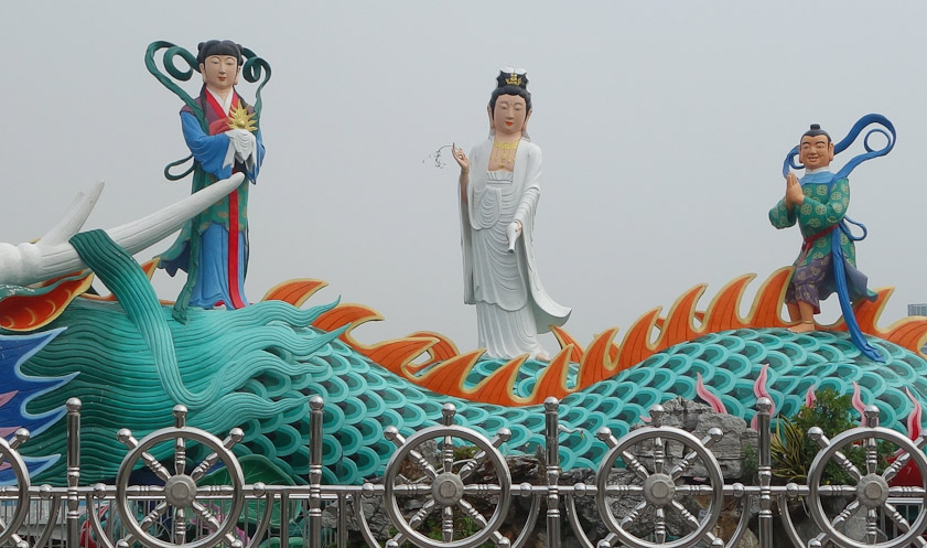 Here is a closeup of the three figures atop the dragon in a photo I took in 2007.