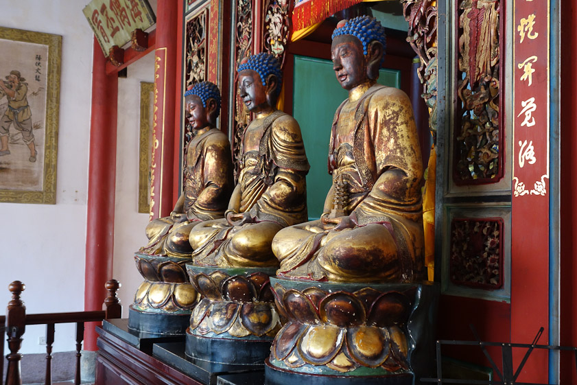 Gilded Buddhas with blue hair.