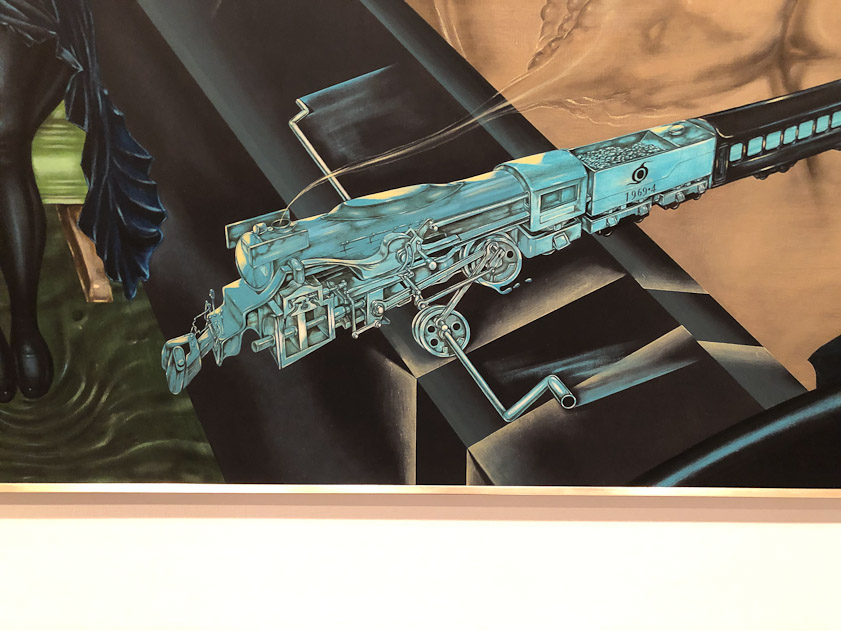 The locomotive curves around to enter the car shrunken and powered by a hand crank.