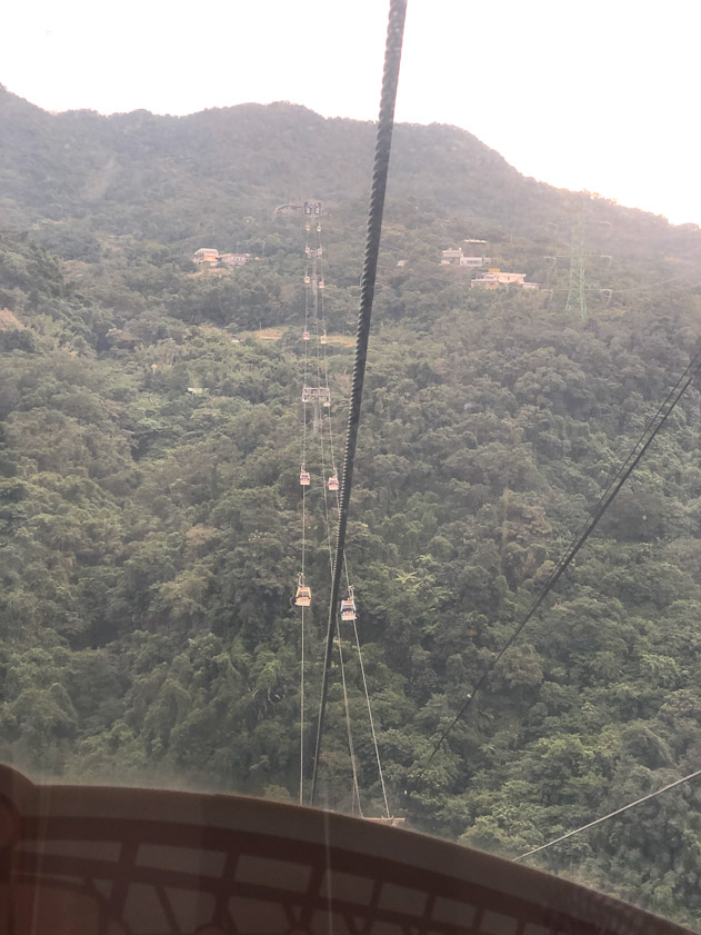 The gondola goes up and down the hills.